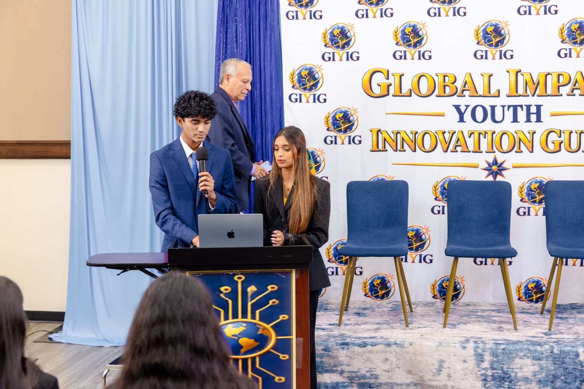 YRI Fellows presenting on stage at the Global Impact Youth Innovation summit